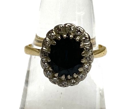 A vintage ‘Sapphire’ and diamond cluster ring, 18 carat gold setting,  yellow gold, claw set, with oval cut deep dark blue gr