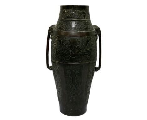 A Chinese Archaistic bronze Hu type vase, Qing Dynasty,  of tall ovoid form, with three horizontal bands, decorated with pane