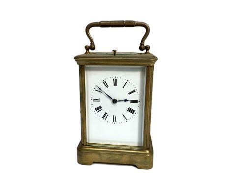 A French brass repeater carriage clock, late 19th century or early 20th century,  in a typical four glass and gilt brass corn