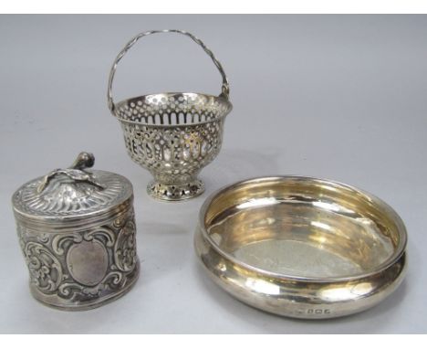 1920s silver coaster of circular form, 13cm diameter; together with a further pierced silver basket with handle and further f