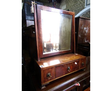 A Georgian  mahogany veneered toilet mirror of rectangular form with moulded column supports raised on a box base fitted with