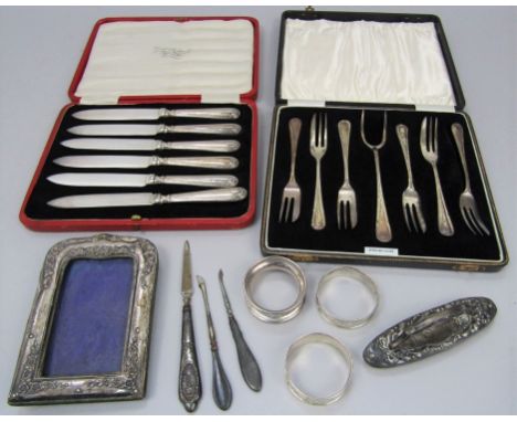 A mixed collection of silver to include a cased suite of dessert forks, cased set of six silver handled fruit knives, three n