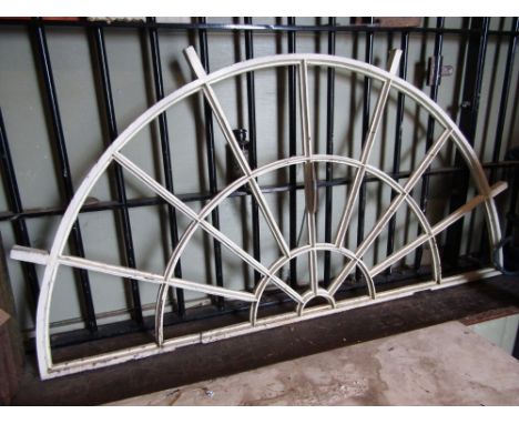 A cream painted cast iron framed fan light with segmented vacant panels approx 4ft wide x 2ft high