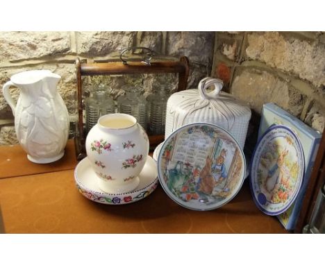 Oak cased three bottle Tantalus together with a further ironstone cheese dish and cover, Poole pottery dish, a Peter Rabbit c