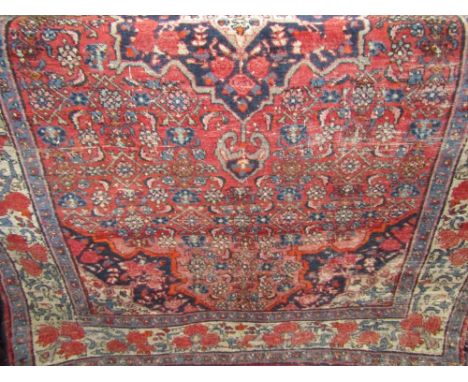 Two Persian rugs each with scrolled foliage upon a light ground