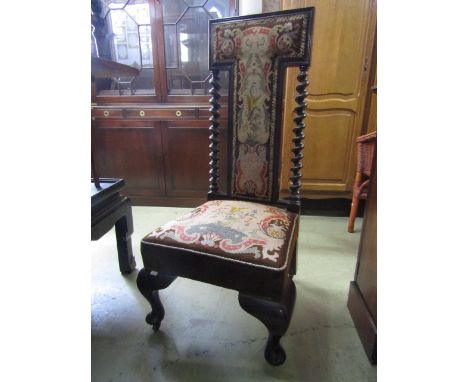 A Victorian prayer/nursing chair with tapestry upholstered seat and T shaped back within a show wood frame raised on squat ca