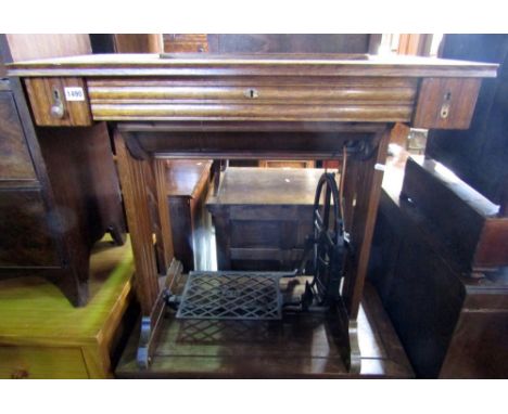A vintage Pfaff oak cased treadle sewing machine with moulded framework
