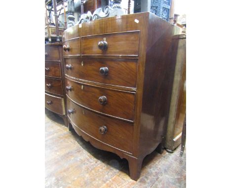 A mid-19th century mahogany caddy top chest of three long and two short drawers with bow fronted outline, raised on swept sup