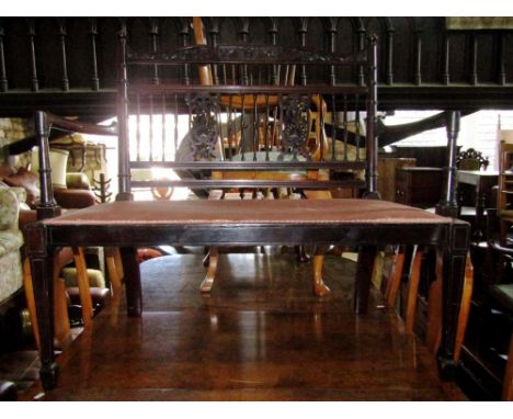 An Edwardian mahogany two seat parlour room sofa, with well carved and pierced splats and further spindle mouldings with carv