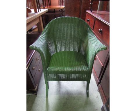 A vintage Lloyd loom chair with swept arms,arched back and original green painted colourway