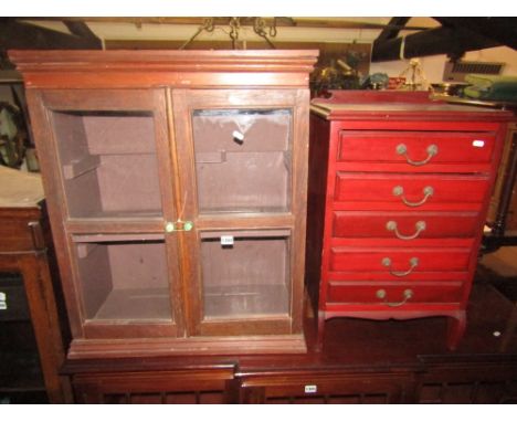 A small oak framed hanging wall cabinet enclosed by a pair of twin moulded glazed panelled doors with shelf to interior toget