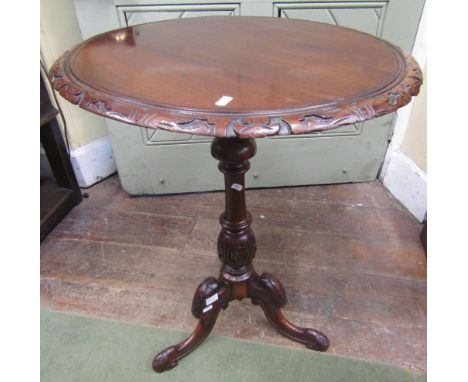 A Victorian mahogany occasional table, the carved column support with tripod base, the circular top with carved borders