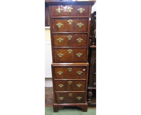 An unusually small Queen Anne style walnut veneered chest on chest, seven drawers with cross banded detail and with brass fit