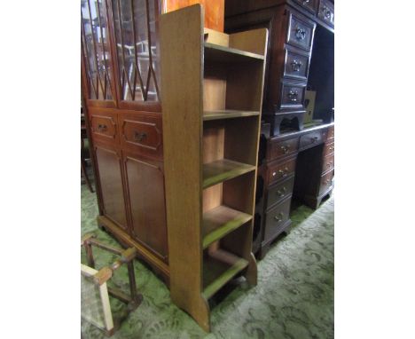 A small Arts and Crafts light oak freestanding open bookcase with fixed shelves and pierced detail, 39 cm wide x 25 cm deep x