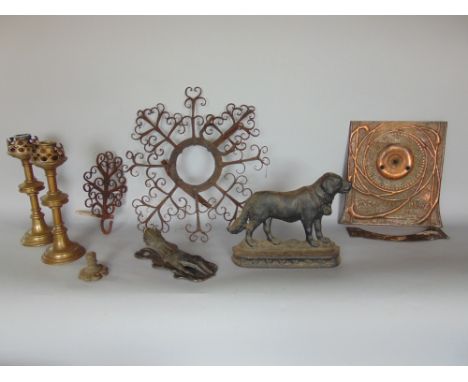 A box of metal ware to include a cast iron door stop in the form of a Labrador, a pair of ecclesiastical candlesticks, a door