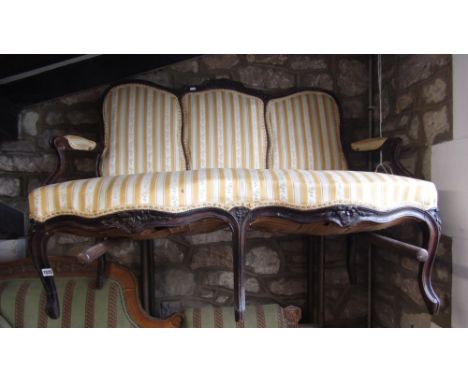 A 19th century drawing room sofa with carved and moulded show wood frame, upholstered seat, back and arm panels, raised on sh