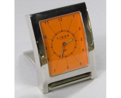 Links of London silver plated travel alarm clock, the bright orange dial with Arabic, within an articulated easel case, 6.5cm