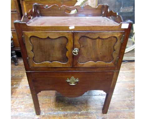 A Georgian mahogany tray top commode, the three quarter shaped and raised gallery over a pair of panelled doors, raised on sq