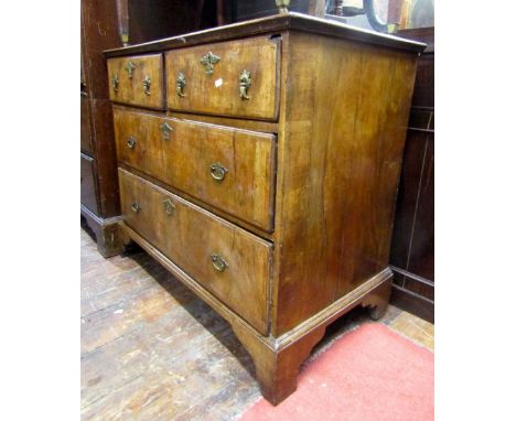 A small 18th century countrymade walnut veneered chest of two long and two short drawers, with elm linings, the drawers with 
