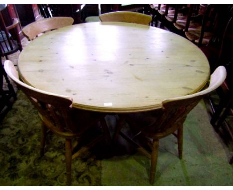 A contemporary but Victorian style stripped pine breakfast table of circular form with moulded outline raised on a central va