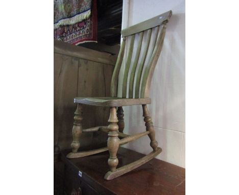 A Windsor elm and beechwood lathe back rocking chair on turned supports and stretchers together with a Victorian cast alloy o