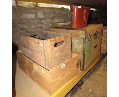 A vintage pale green canvas travel trunk with leather borders and brass fittings, two vintage timber crates and a pair of cas