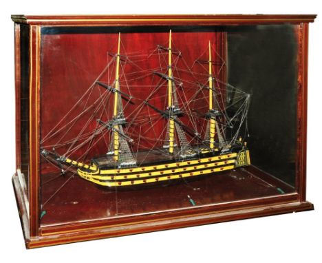 A model of HMS Victory, 90cm long within a mahogany and glass floor standing cabinet raised on turned supports