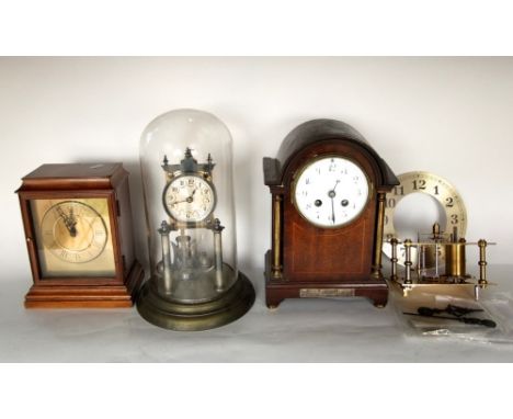A collection of vintage time pieces to include an antique torsion clock under a glass dome, a further two train mahogany mant