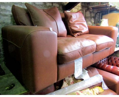 A two seat tan coloured leather sofa, with deep seat and loose cushions, 2m wide approx