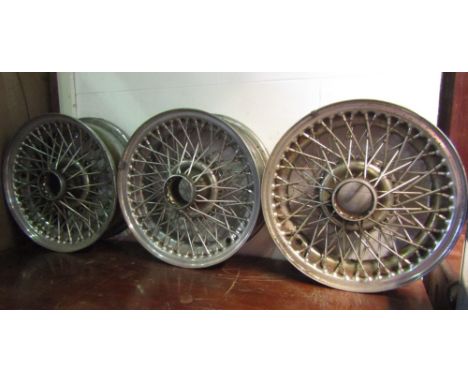 Nine Dunlop 72 cross spoked wire wheels originally fitted to a Jaguar 3.8 E type grand touring model, together with a service