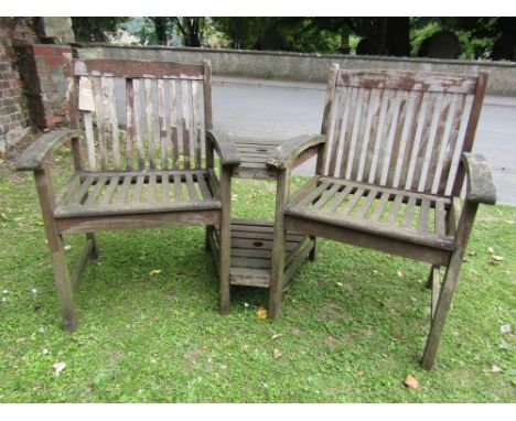 A weathered contemporary hardwood twin companion bench, with open arms, slatted seat and back joined by a central two tier sl