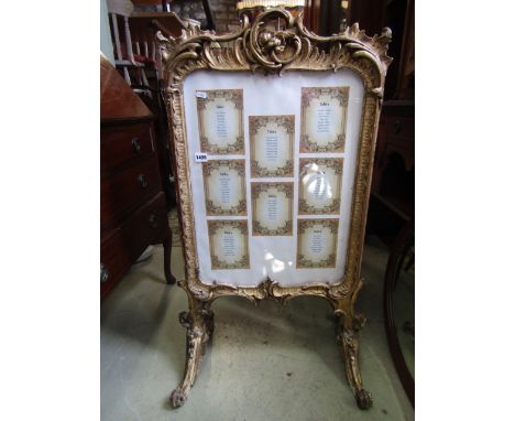 A 19th century fire screen with scrolling gilt acanthus frame and supports