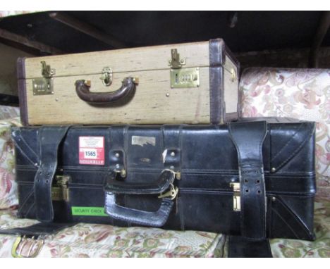 A vintage canvas suitcase with leather bands, by D Cassegarin of Paris and a further black leather suitcase by Peacock