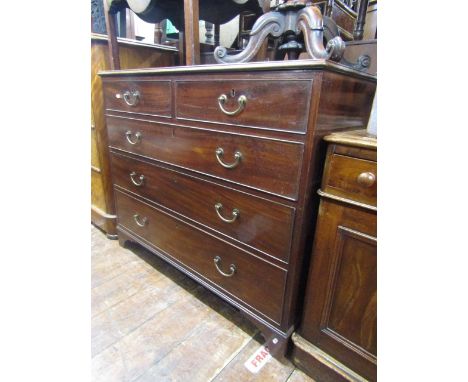 A Georgian mahogany chest of three long and two short drawers, with brass fittings, the top with cross banded borders and str