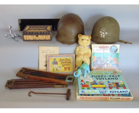 A mixed lot to include a porcupine spill box, two military helmets, two tripod stands marked Kodak, a Mickey Mouse book publi