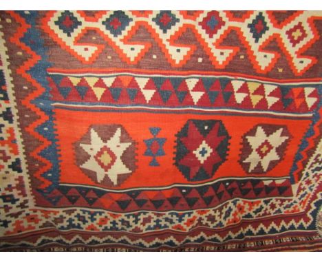 Kelim flat weave carpet decorated with bands of orange and blue medallions upon a light ground, 260 x 135 cm