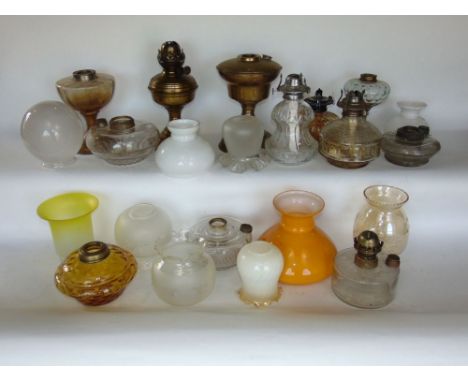 A collection of vintage oil lamps and shades