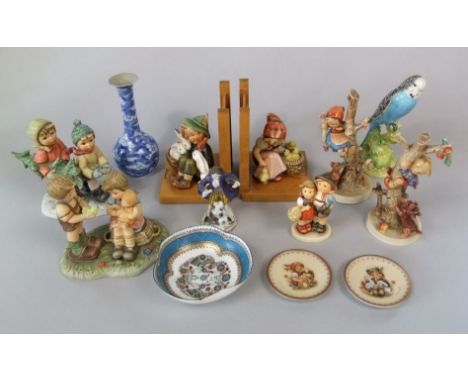 A collection of Hummel figures including a pair of bookends with children and their pets beside wooden gates, a pair of figur