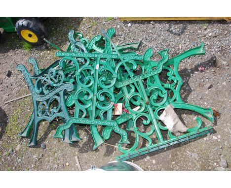 A quantity of green painted cast iron table and bench ends.