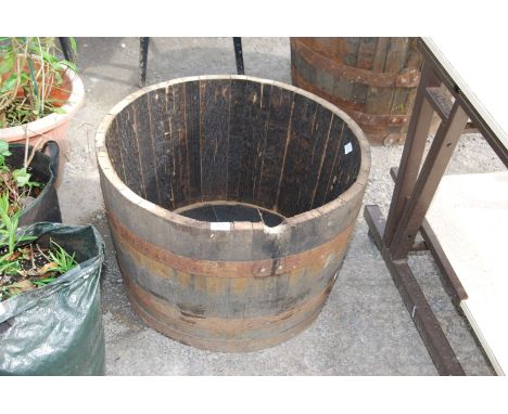 A semi circular whisky planter 25" diameter x 16" deep.