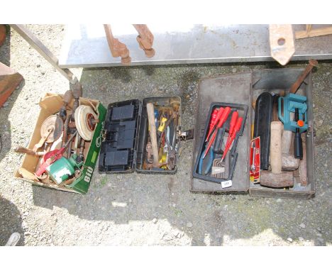 A metal toolbox, baluster chisels, small bench clamp, plastic toolbox, oil cans and hand drills.