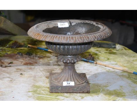 A small cast iron planter, 8'' high x 11'' diameter max.
