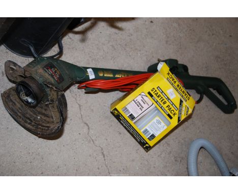 A Black &amp; Decker strimmer, cord attachment and oil.