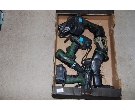Three cordless drills, a light and a charger unit