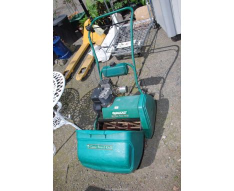 A Qualcast cylinder mower, (engine turns at time of lotting).
