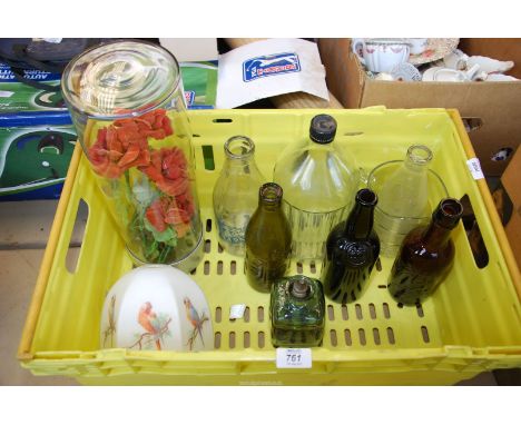 A box of glass, advertising milk bottles, old beer bottles, silver stopper and parrot decorated lamp shade.