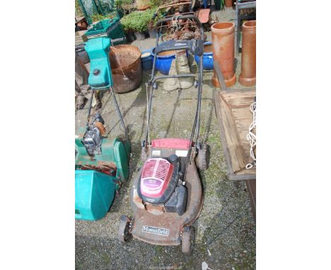 A Honda lawn mower, (engine turns at time of lotting), no grass box.