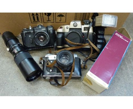 A Zenit EM and a Zenit-E camera, both with Helios 44 lenses, a Photax 300mm pre-set f5.6 lens and an Olympia camera