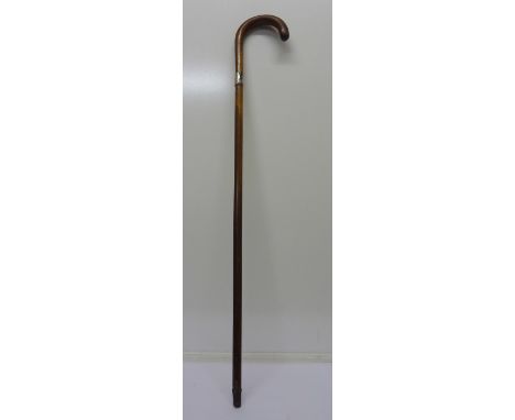 A silver-rimmed walking stick