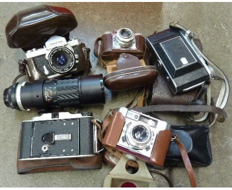 A Nikon Nikkormat camera, Paxette and other cameras including folding and a telephoto lens
